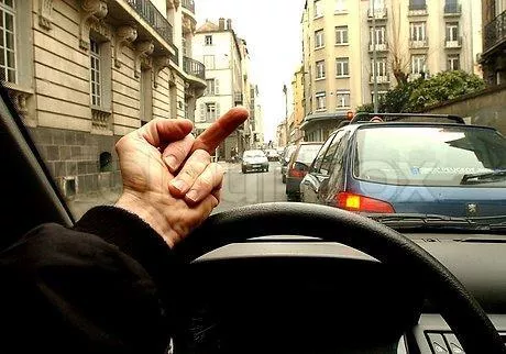 Instant karma comes quick to those who don’t play nice on the street A man showing his middle finger from inside the car