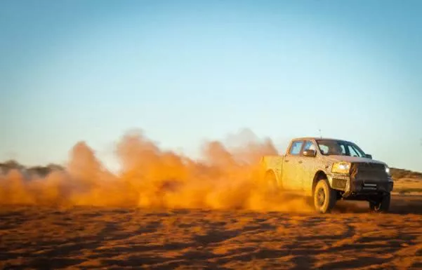 Angular front of a Ranger Raptor running on sand