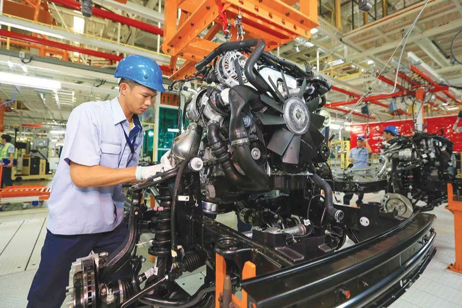 A picture of a Ford employee checking an engine