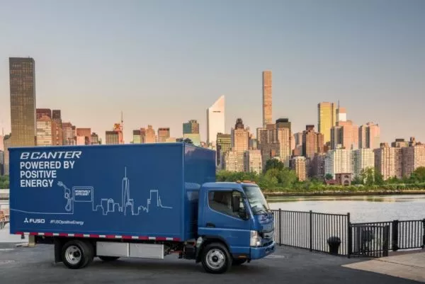 A blue all-electric Fuso eCanter on the road