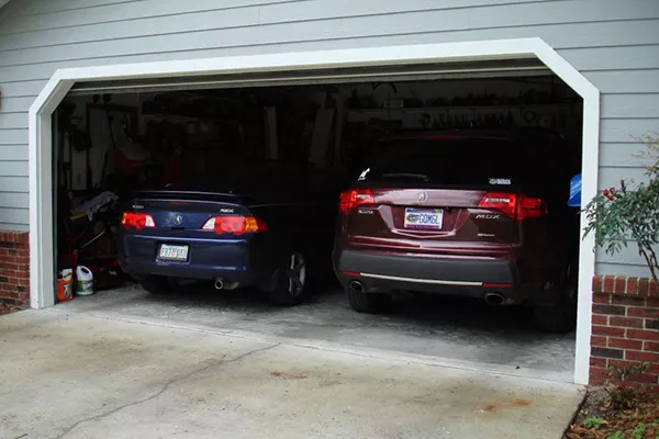 A picture of two Acura vehicles parked in a home garage