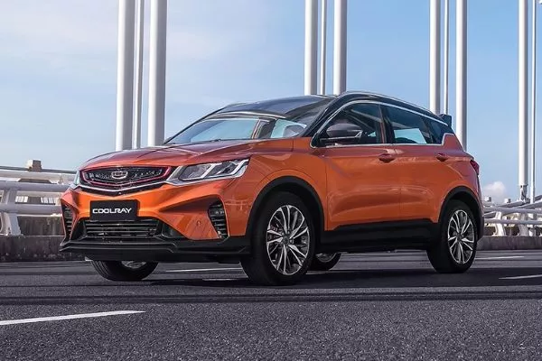 An orange Coolray on a street