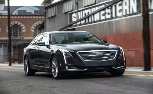 A black General Motors car on the road