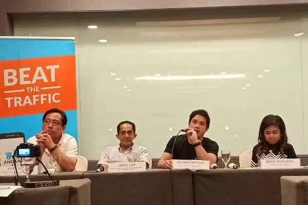 Angkas, represented here by George Royeca, has been working with the government to tackle our nation's transport woes. A picture of George Royeca with several government officials.