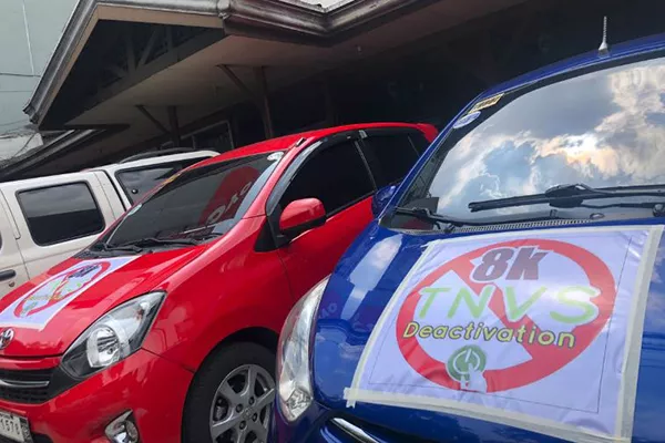 A picture of suspended Grab cars with protest posters