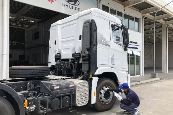 A man inspecting a Hyundai truck