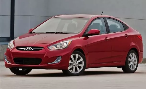 A Red Hyundai Accent angular front view