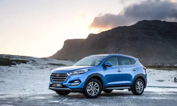 Angular front of a blue Hyundai Tucson