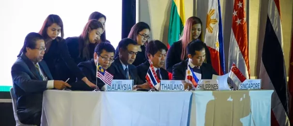 agreements being reviewed by a group of people from Malaysia, Thailand, the Philippines and Singapore