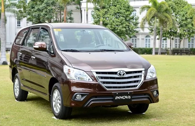 A brown Toyota Innova angular front view