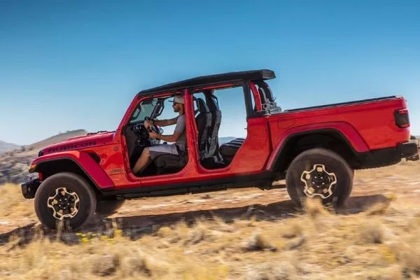 A picture of the Jeep Gladiator travelling fast over a hill