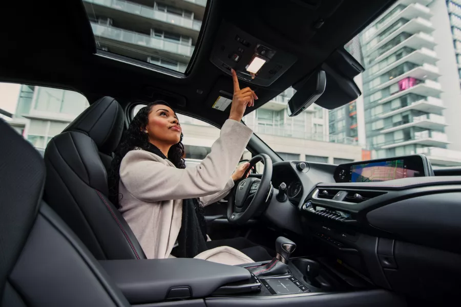 A woman testing the features on a Lexus. 