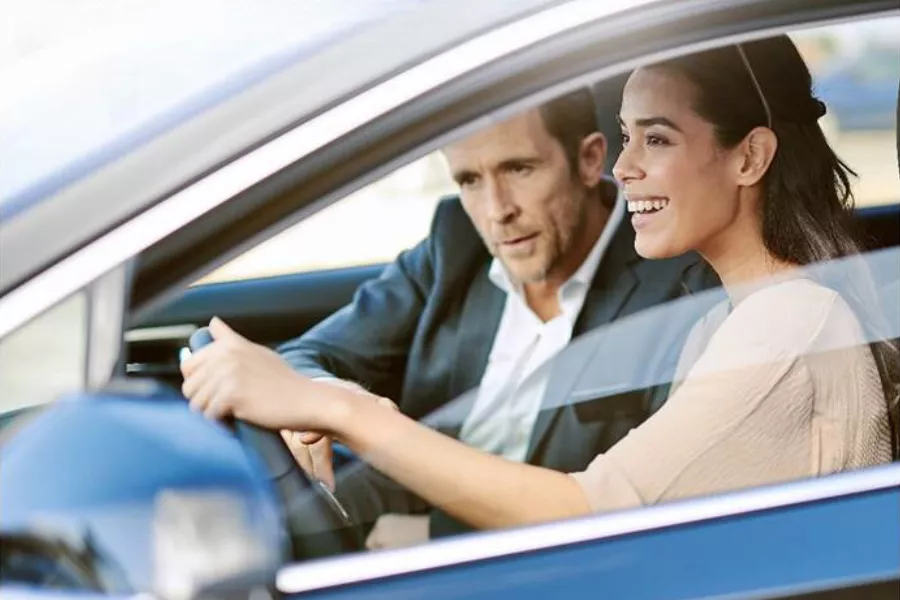 A woman test driving a Lexus. 