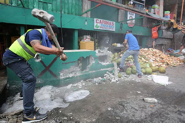 LGU employees destroying an illegally constructed structure