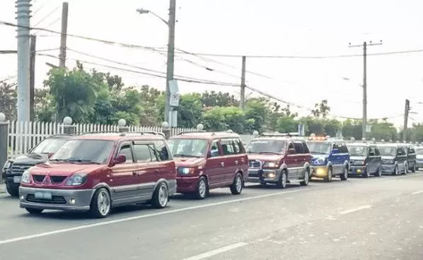 a line of Mitsubishi Adventure on street