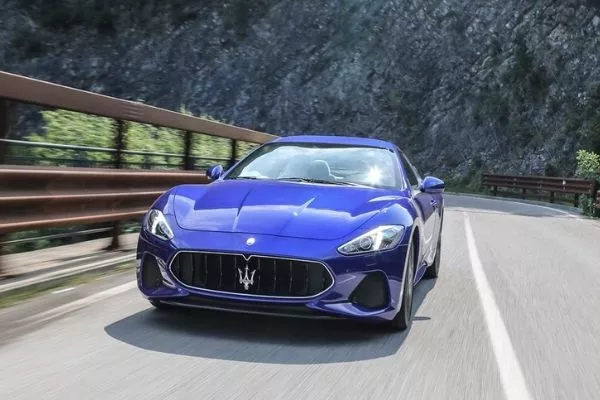 The Maserati Granturismo in its natural habitat A picture of the Maserati Granturismo on a mountain road.