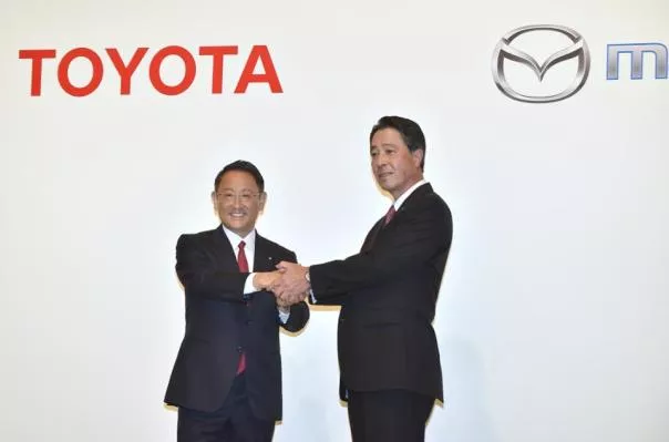 Toyota CEO and Mazda CEO shake hands on their agreement 