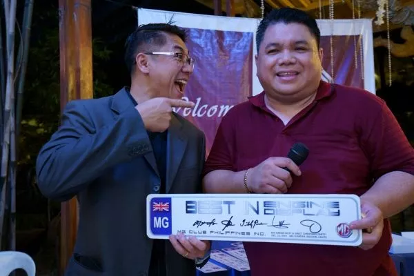 A picture of the MG Car Club President presenting an award