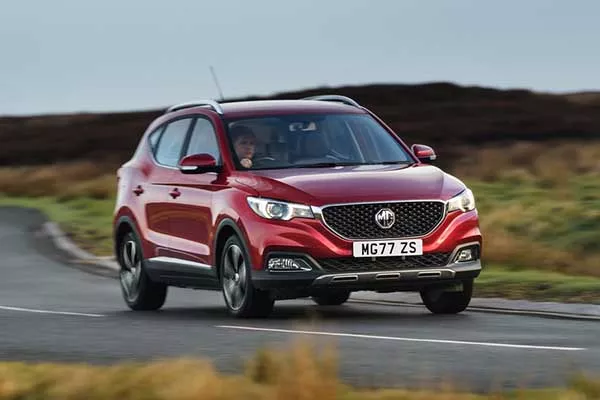 A red MG ZS on the road