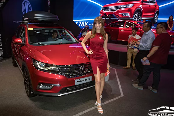 The MG RX5 compact SUV is both functional and stylish; the perfect combination of style and substance A picture of the MG RX5 compact SUV's front end and a beautiful carshow girl.