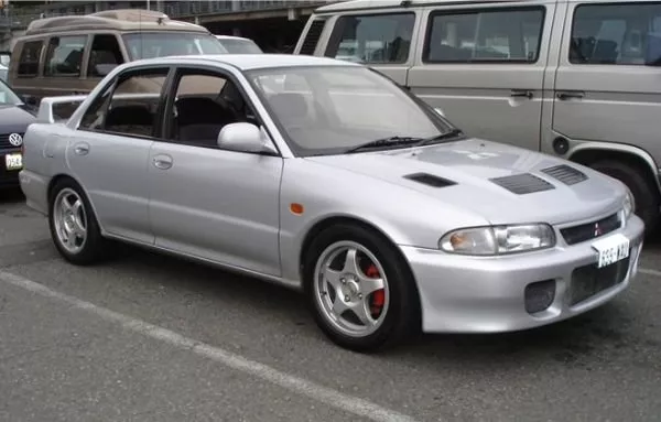 A picture of the first ever Lancer EVO i on a parking lot