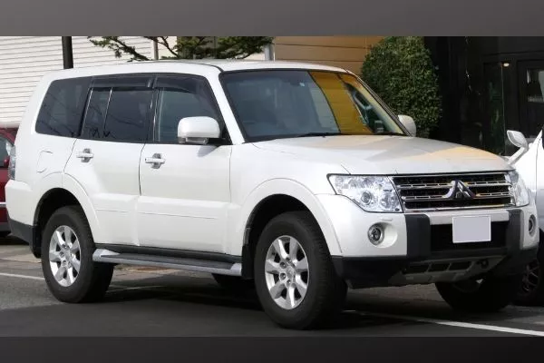 A picture of a white Mitsubishi Pajero parked on the side of a road