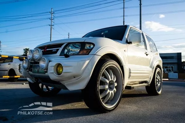 mitsubishi pajero 3 door against the sunset