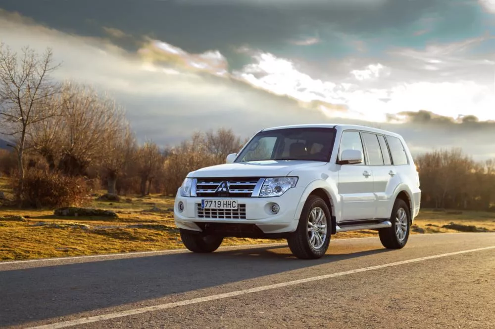 The driver of the Misubishi Pajero is usually an old man who is probably in the 50s. angular front of a white Misubishi Pajero