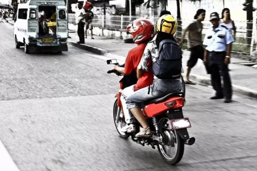 A man and his daughter riding on a motorcycle