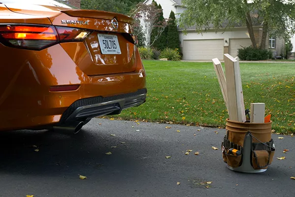 A picture of a Nissan Sentra backing out of a parking spot.