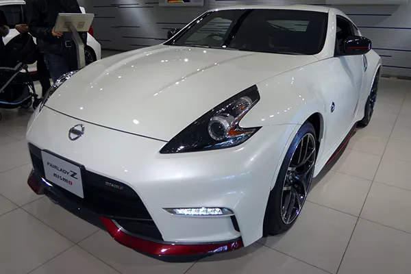 A front view of the Nissan 340z at a Japanese car show.