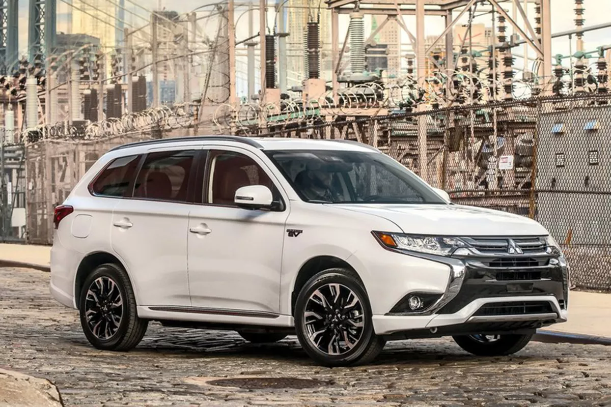 A picture of a Mitsubishi Outlander PHEV parked on a cobbled road