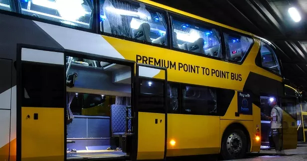 A yellow premium point-to-point bus