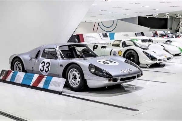 A picture of several cars in the Porsche museum