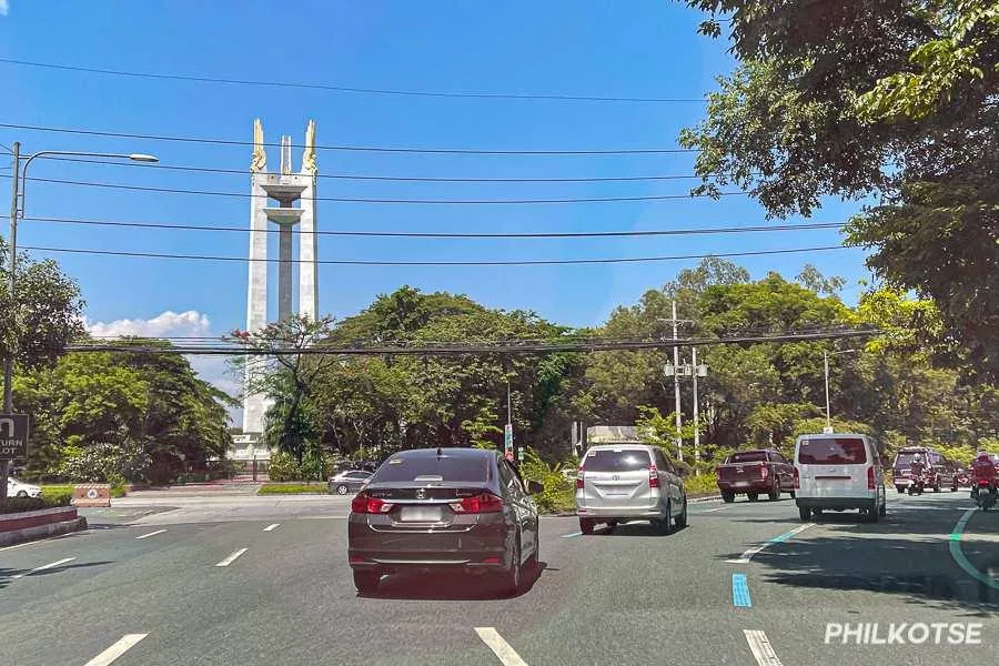 A picture of cars on the QC memorial circle