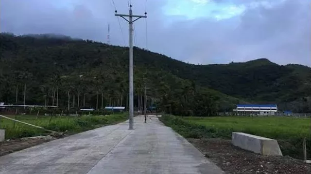 Electric posts in middle of Tacloban road 