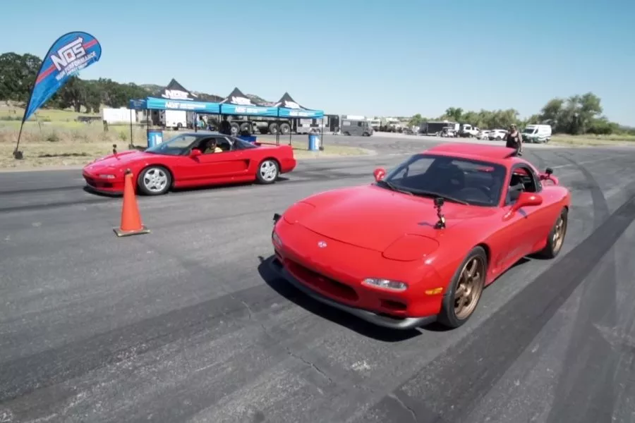 A picture of the NSX and the RX-7 on the drag strip starting line