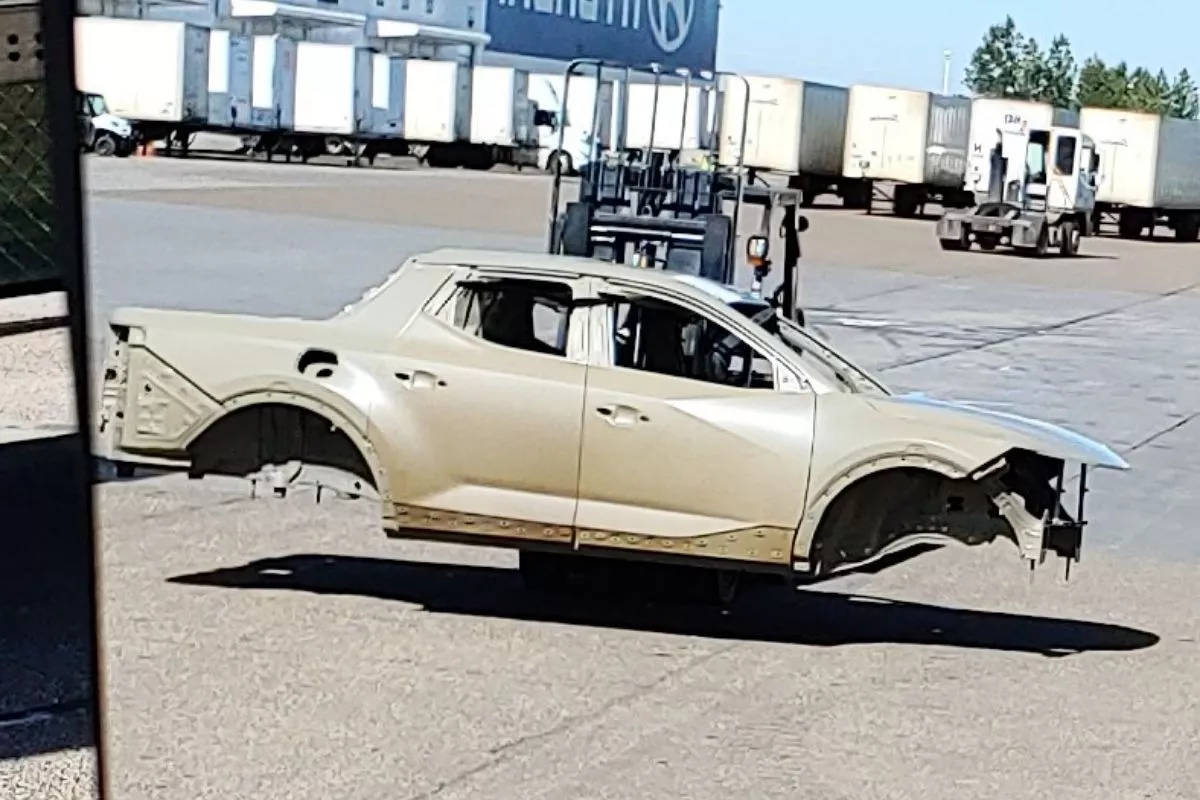 The shell of the 2021 Hyundai Santa Cruz truck being carried by a forklift