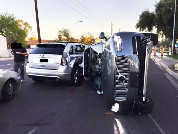 an Uber self-driving Volvo XC90 flipped over on its side