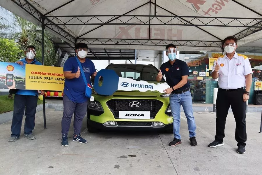 A picture of Julius Drey Latag recieving his brand new Hyundai Kona