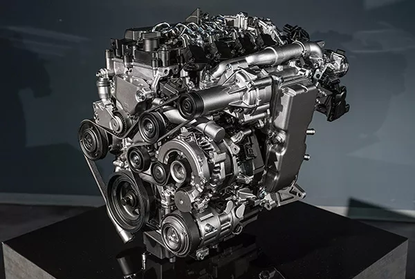 The new Skyactiv-X will use compression just like a diesel engine. A picture of the new Skyactiv-x mazda engine with a dark background.