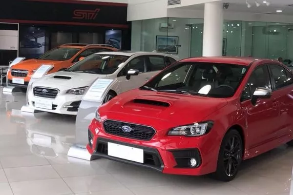 A picture of a Subaru showroom with STI models