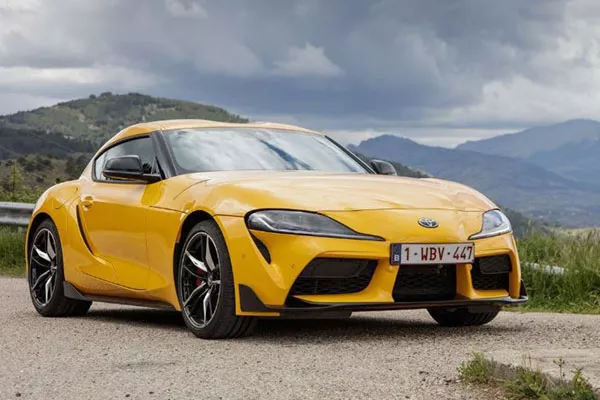 A picture of a yellow toyota Supra