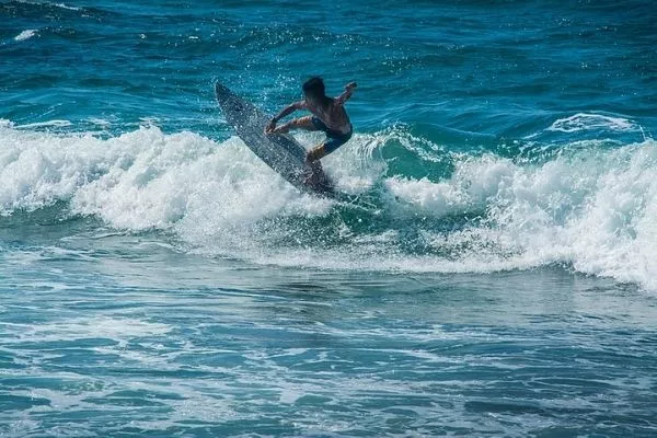 A boy surfing in a beach