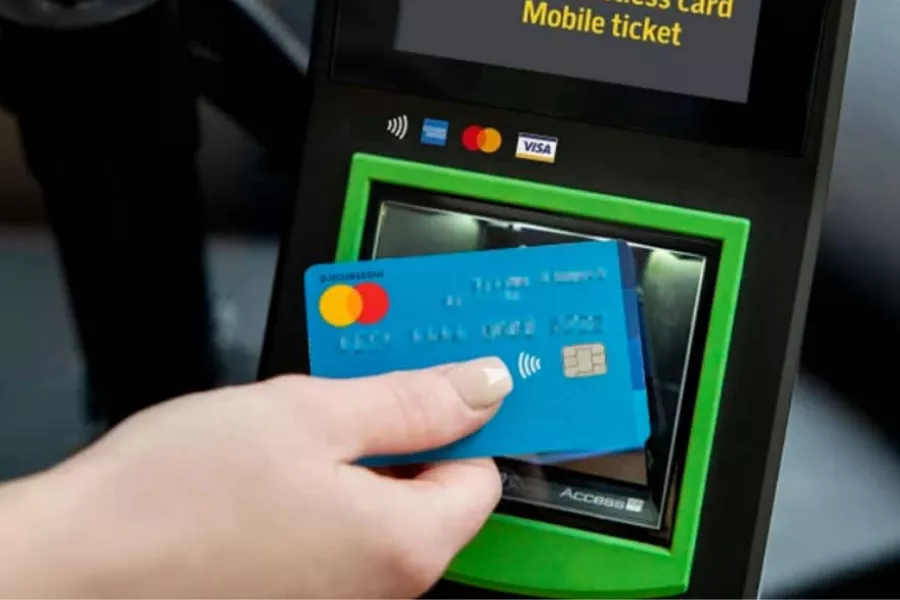 A picture of a person tapping a card for fare payment