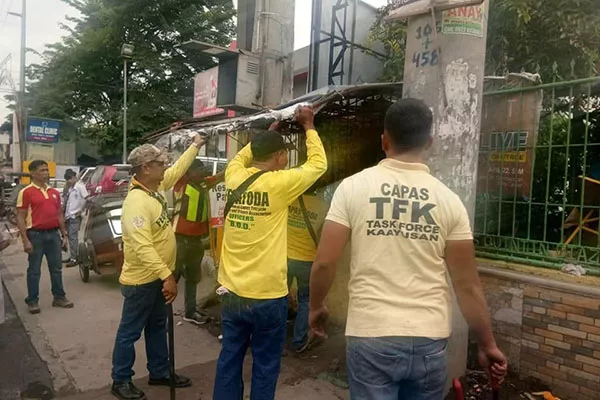 Barangay officals performing road clearing operations in Tarlac