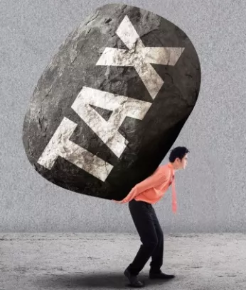 Car owners to get a triple whammy of taxes on motor vehicles, fuels and car registration fees A man carrying a huge stone carved with Tax