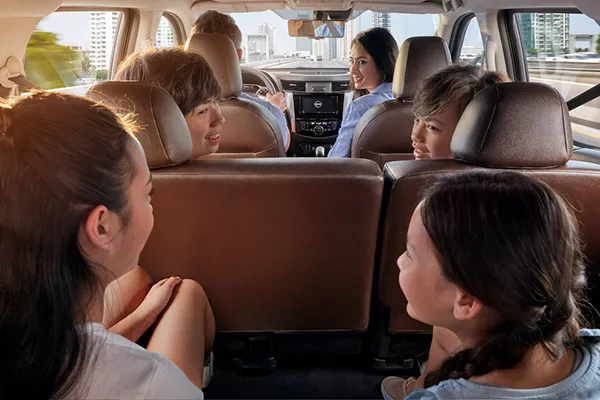 A picture of a family riding an SUV