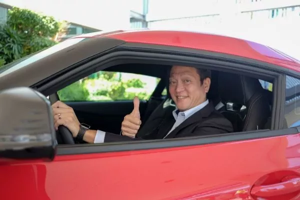 A picture of President Okamoto aboard the Toyota GR Supra