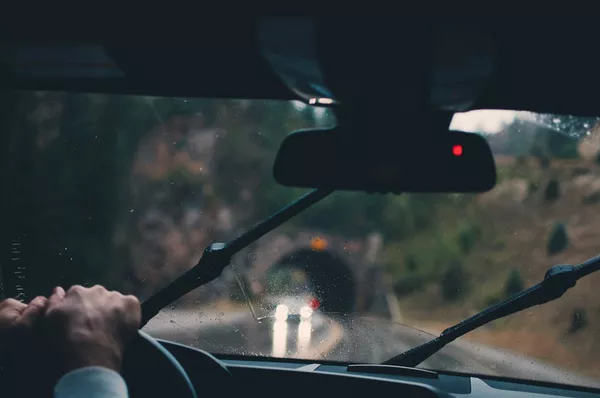Man behind the wheel about to go through a tunnel